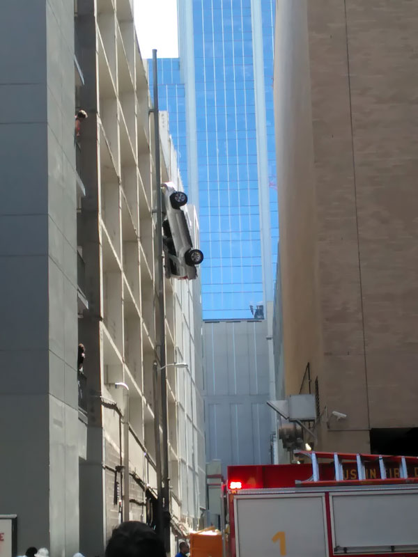 Car hanging from parking garage in Austin